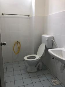a white bathroom with a toilet and a sink at Medina Homestay, Wakaf Che Yeh in Kota Bharu +15 photos