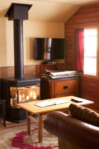 a living room with a stove and a fireplace at Hillside Bungalows in Banff