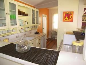 a kitchen with a sink and a counter top at Casablanca Enchanted Cottage in Nelson Bay