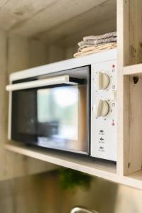 a microwave oven sitting on a shelf at 3BD Apartment in the Center in Patra