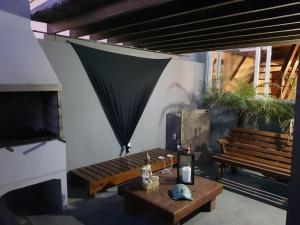 a living room with a bench and a table at Bellapraia Apart Hotel in Rio Grande