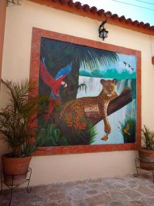a mural of a jaguar on the side of a wall at Hotel Tierra Maya in San Cristóbal de Las Casas