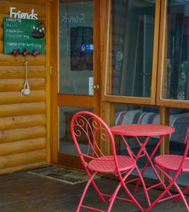 two red chairs and a table on a patio at Friends at McLaren Vale in McLaren Vale