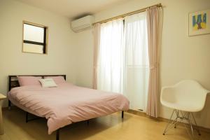 Postel nebo postele na pokoji v ubytování Spacious & Modern Inn Megumi-an Nishijin