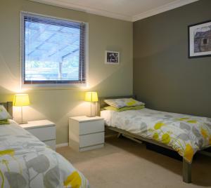 a bedroom with two beds and a window at Friends at McLaren Vale in McLaren Vale