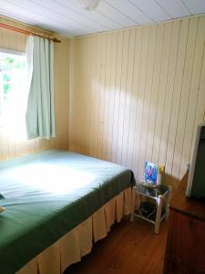 a bedroom with a bed and a window and a television at A Casa do Rio in Lages +60 photos