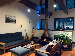 a living room with a couch and a fireplace at Bears Den Mountain Lodge in Hakuba