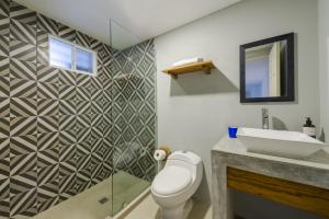 a bathroom with a toilet and a sink at Gaia Studios in Cancún +34 photos