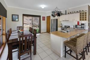 a kitchen and dining room with a table and chairs at Mt Taylor Country Retreat in Mount Taylor