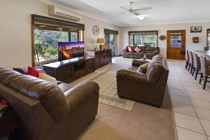 a large living room with couches and a tv at Mt Taylor Country Retreat in Mount Taylor