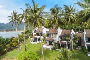an aerial view of a house with palm trees at Kamala Beach Estate Apartment - SHA PLUS in Kamala Beach