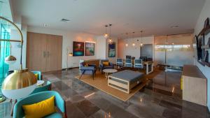 a living room with furniture and a dining room at Holiday Inn & Suites - Merida La Isla by IHG in Mérida