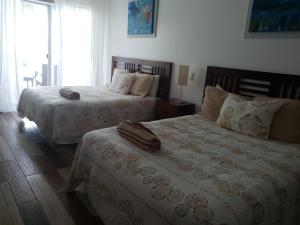 Tempat tidur dalam kamar di Palmeraie Terrenas Beach Apartment