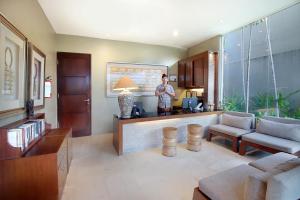 a man is standing in a living room at Kanishka Villas in Seminyak