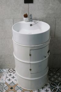 a bathroom with a white sink and a toilet at NATIVUS Art-Hostel in San José