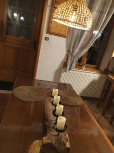 a dining room table with candles on top of it at La Pénates in Château-Regnault-Bogny