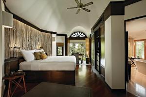 a bedroom with a large bed and a bathroom at Rayavadee- SHA Extra Plus in Railay Beach