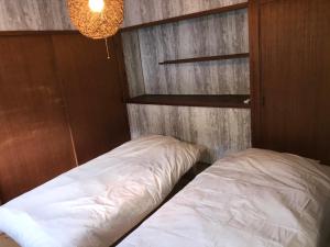 a bedroom with a bed and a chandelier at 蒼 aoi in Shingū