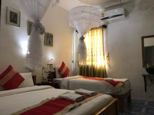 Cama o camas de una habitación en Thavisouk Guesthouse