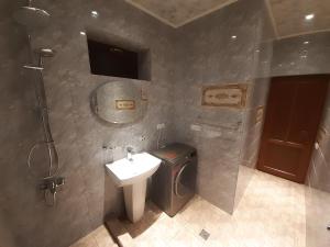 a bathroom with a sink and a toilet and a shower at Cottage Green Garden in Tsaghkadzor +30 photos