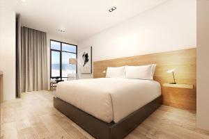 a bedroom with a large white bed and a desk at Signature by The Concept in Kuah