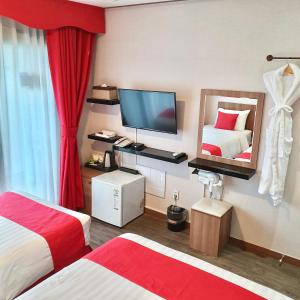 Postel nebo postele na pokoji v ubytování CS Premier Hotel