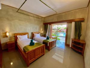 Vuode tai vuoteita majoituspaikassa Odiyana Bali Retreat