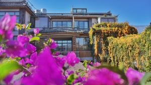 a house with pink flowers in front of it at Z.Garden in Dali