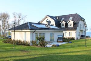 a house with solar panels on top of it at Waldpavillon in Fehmarn