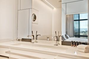 a bathroom with a sink and a mirror at COOL MAMA Salzburg in Salzburg