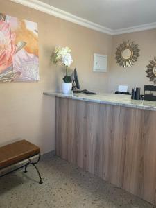 a reception desk in a waiting room with flowers on the counter at The Hill Hotel and Conference Centre in Thohoyandou