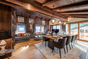 a dining room with a long table and chairs at Balegia Luxury Apartments in Lech am Arlberg