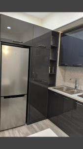 a kitchen with a stainless steel refrigerator and a sink at Tbilisi App 3 in Tbilisi City +14 photos