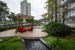a garden with two red chairs and a pond at Swiss-Garden Hotel & Residences, Genting Highlands in Genting Highlands
