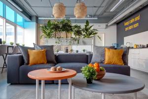 a living room with a blue couch and a table at Roomy Hostel in Yekaterinburg