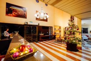 a living room with a christmas tree and a table at Hotel Da Porto in Vicenza