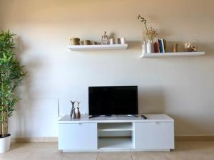 a white entertainment center with a flat screen tv on it at Vv Bimba in Frontera