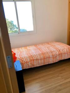 a bed sitting in a room with a window at Vv Bimba in Frontera