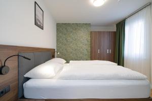Łóżko lub łóżka w pokoju w obiekcie MyApartments Vienna