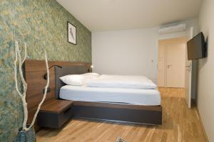 Łóżko lub łóżka w pokoju w obiekcie MyApartments Vienna