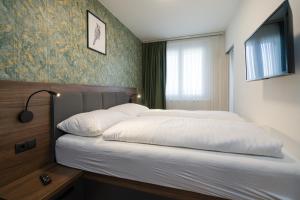 Łóżko lub łóżka w pokoju w obiekcie MyApartments Vienna