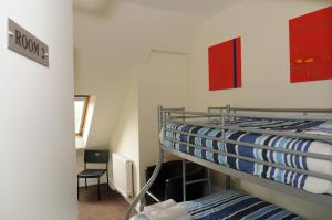 a bunk bed in a small room with a chair at The Hostel in Edinburgh