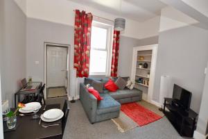 a living room with a couch and a table at Perfect location for Racecourse and town centre in Cheltenham