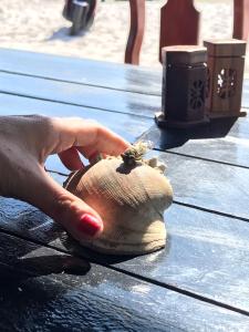 a hand holding a persons foot on a wooden table at Soksan Natura Beach in Koh Rong Island