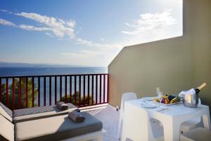 a balcony with a table and a view of the ocean at Skiathos Palace Hotel in Koukounaries