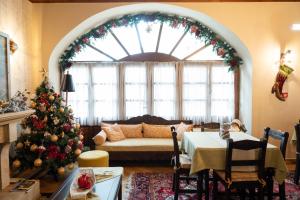 a living room decorated for christmas with a christmas tree at Kaza Guesthouse in Dimitsana