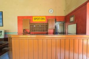 a bar in a restaurant with a sign that says spot on at OYO 2465 Hotel Raung View in Banyuwangi