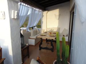 a living room with a table and a couch at Casa Sol & Mar in Sant Josep de sa Talaia