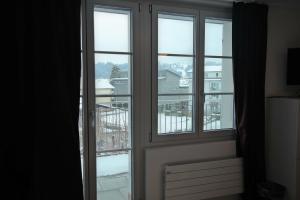 a window with views of a city at Gasthaus zum Ochsen in Grosswangen