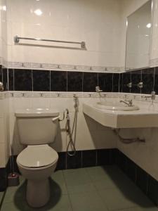 a bathroom with a toilet and a sink at Glory beach resort private apartment in Port Dickson